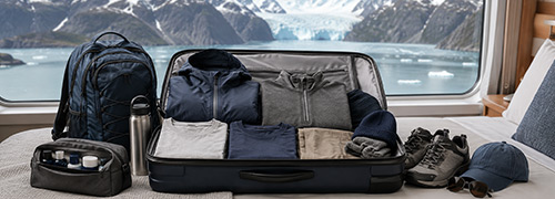 Men's Alaska cruise packing list with layered clothing, hiking shoes, and travel essentials.