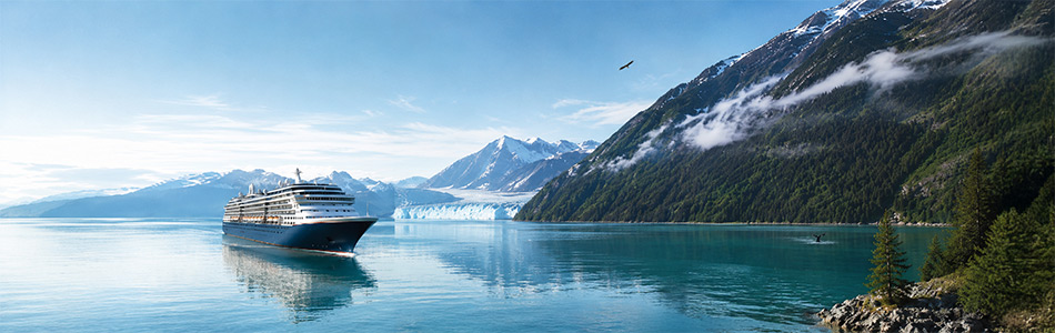 Cruise ship sailing through Alaska surrounded by glaciers and mountains on an Alaska cruise.