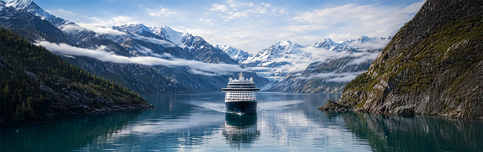 Alaska cruise ship sailing through scenic mountains and coastal waters