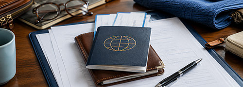 Immigration information documents, passport, and cruise travel paperwork prepared for an upcoming Alaska cruise