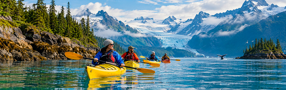 Cruise ship sailing through Alaska surrounded by glaciers and mountains on an Alaska cruise.