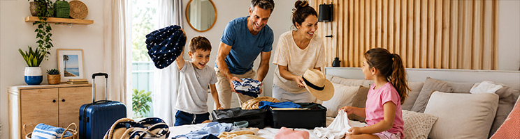 Family packing suitcases and travel essentials while preparing for their first cruise vacation together. Family packing suitcases and travel essentials while preparing for their first cruise vacation together.