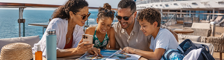 Family planning shore excursions and activities aboard a cruise ship during a summer cruise vacation.
