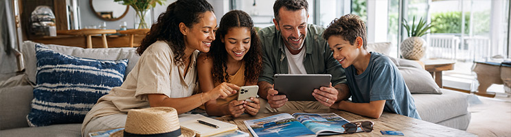 Family researching cruise destinations and planning a summer cruise vacation from home.