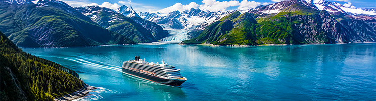 Cruise ship sailing through Alaska's glacier-lined fjords during peak cruise season. Cruise ship sailing through Alaska's glacier-lined fjords during peak cruise season.
